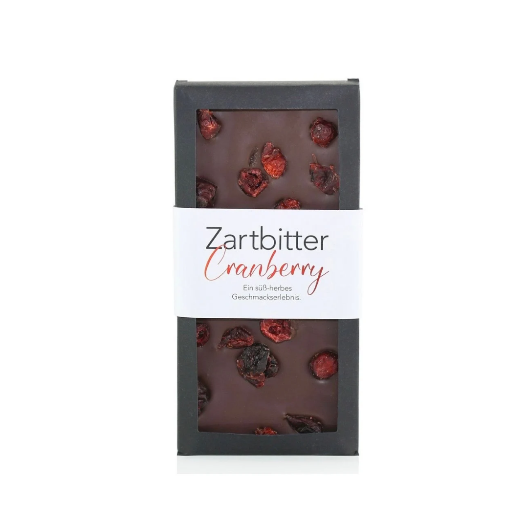 Zartbitter-Cranberry-Schokoladentafel in schwarzer Verpackung auf weißem Hintergrund